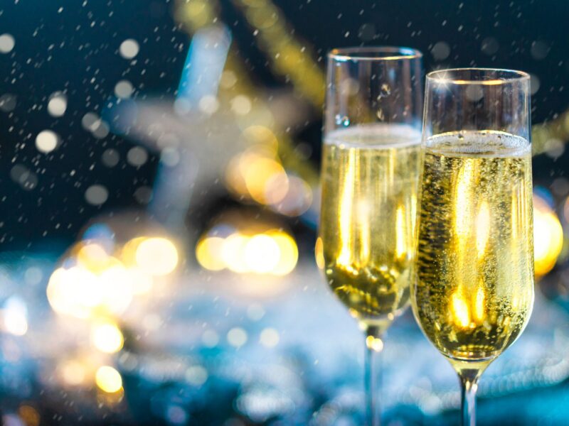 Close-up of two champagne flutes with bubbles, ideal for festive celebrations.