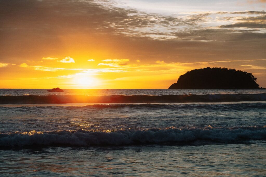 Breathtaking sunset over Kata Beach, Phuket, with vibrant colors and serene waves.