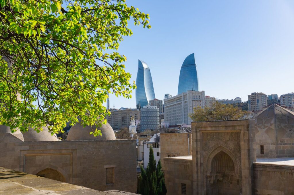Explore Baku's modern skyline with historic architecture in spring.
