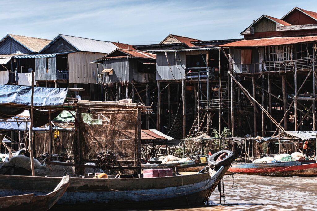 Traditional stilt houses in Kampong Phluk, Cambodia, showcasing unique riverfront architecture.