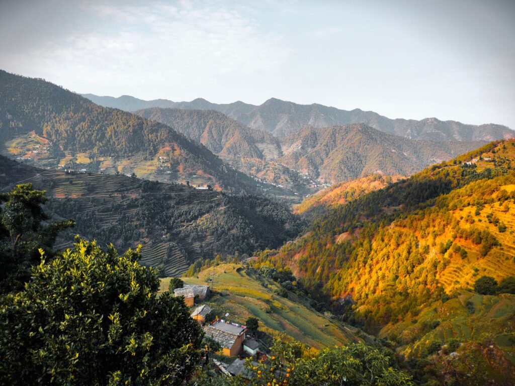 Scenic view of mountains and terraces in Uttarakhand, India, showcasing natural beauty.