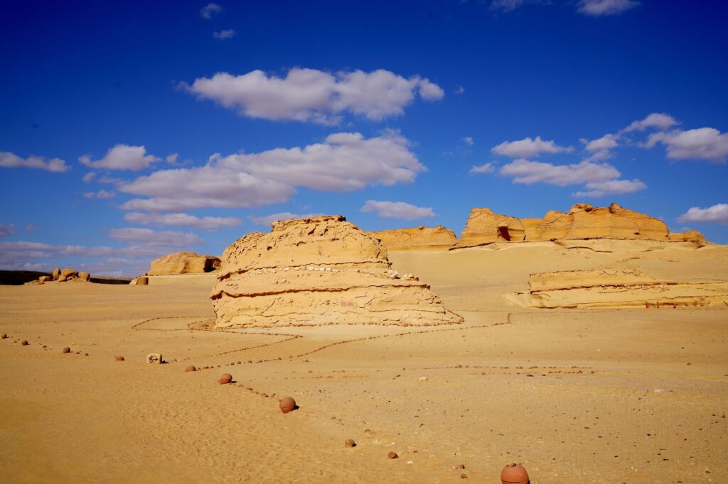 Vast desert landscape with rock formations and a clear blue sky in Egypt.