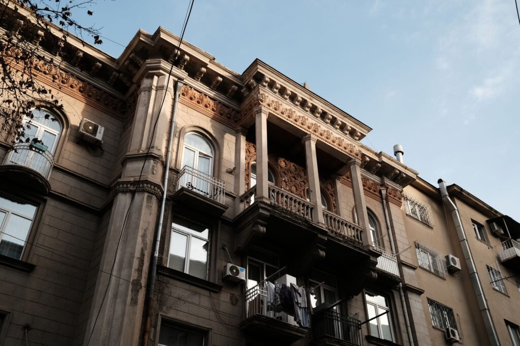 Neoclassical building facade with balconies in Tbilisi, Georgia, showcasing urban residential style.