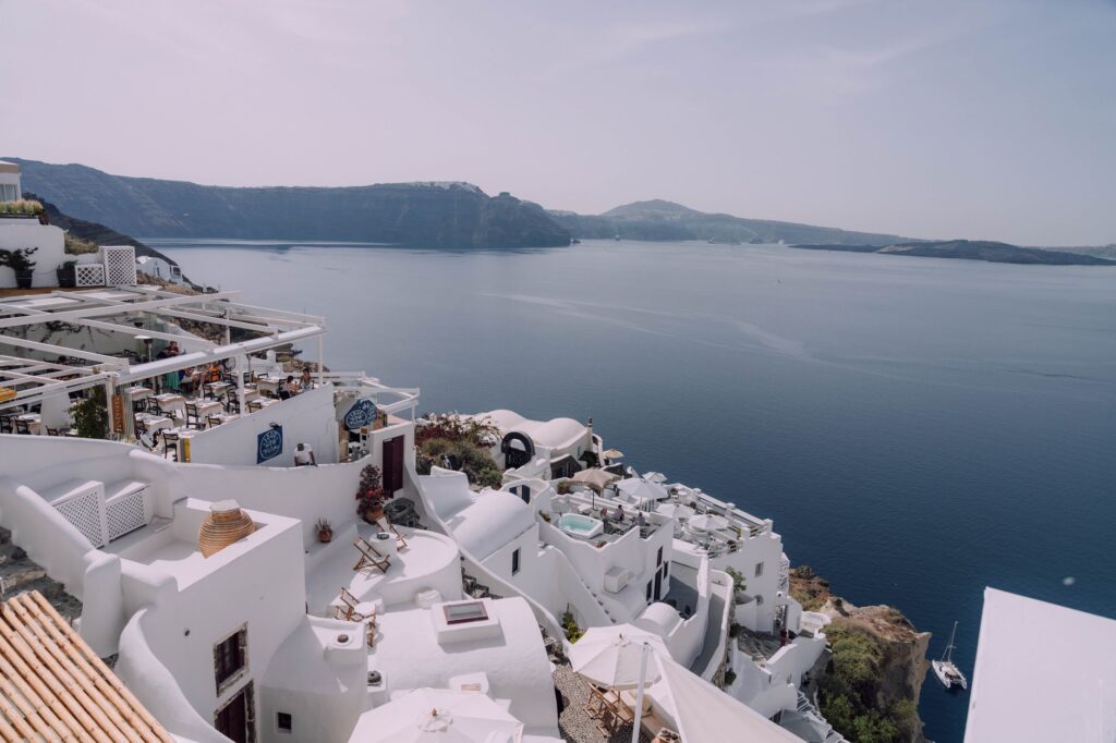 Stunning Santorini view capturing the iconic whitewashed buildings against a blue sea and sky.