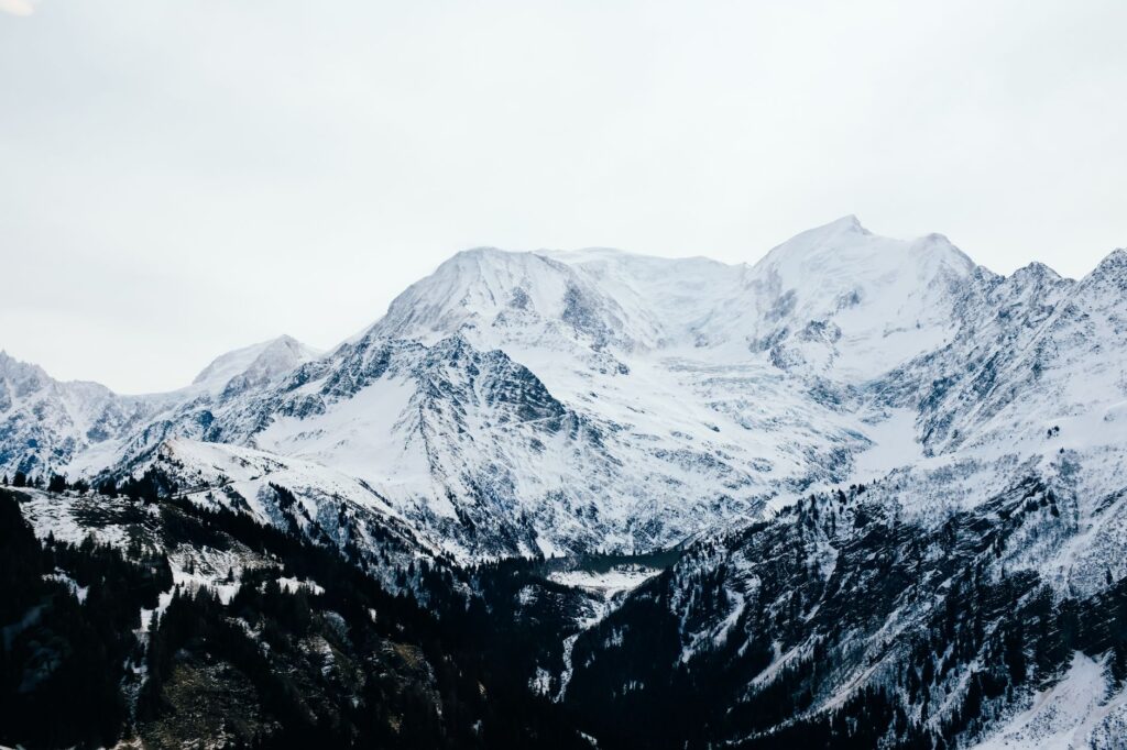 Panoramic view of majestic snow-covered mountains during winter, perfect for adventure enthusiasts.