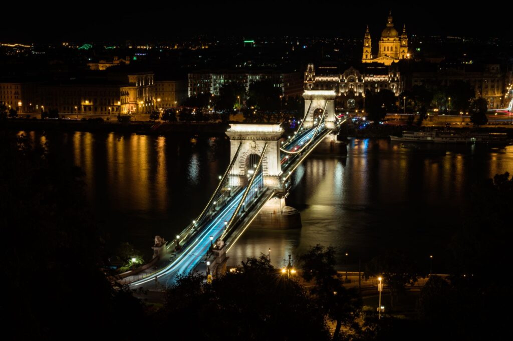 Illuminated Chain Bridge and cityscape in Budapest at night.