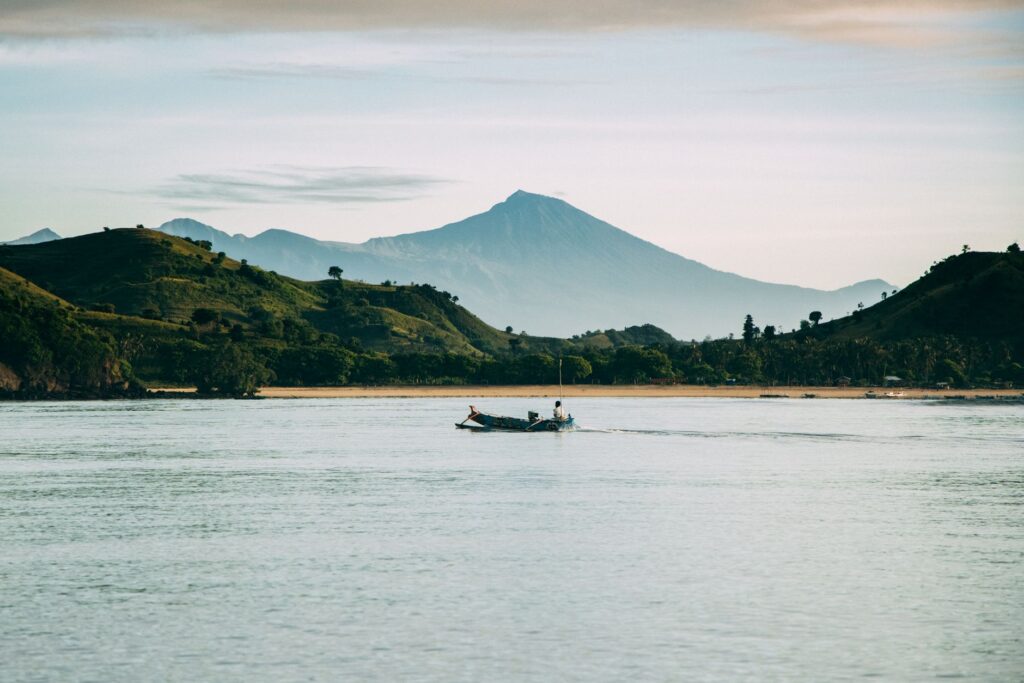 A serene boat ride with a stunning view of Mount Rinjani at West Nusa Tenggara, Indonesia.