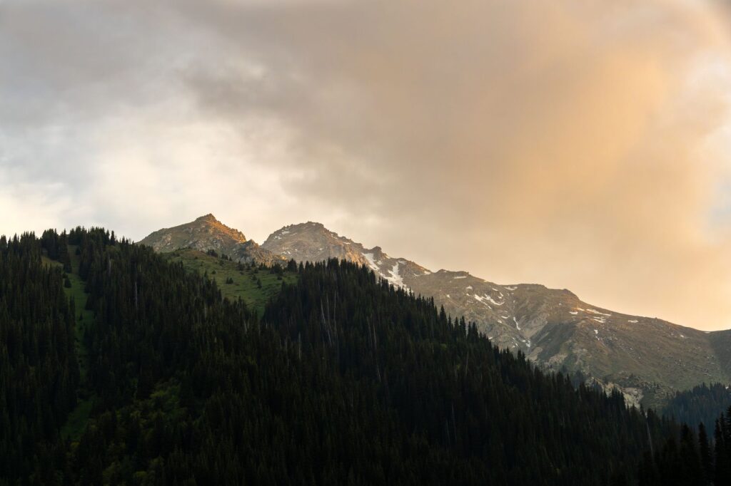 Captivating sunrise over snow-capped mountains in Almaty, showcasing nature's beauty.