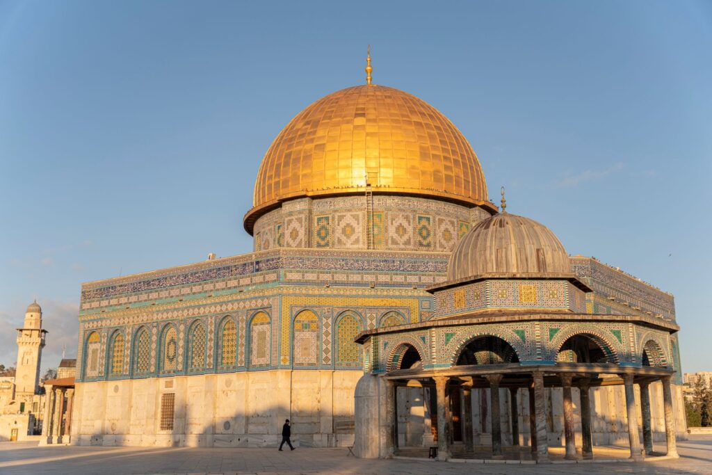 The iconic Dome of the Rock glows at sunrise in Jerusalem's Old City, a landmark of religious significance.
