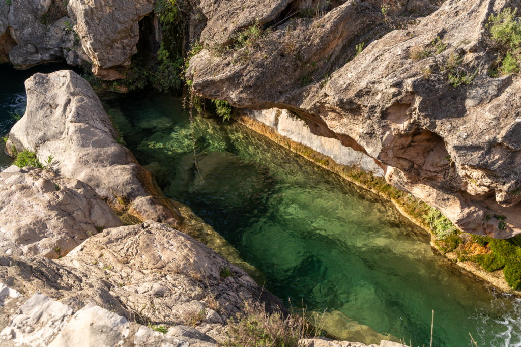 Explore the enchanting natural pool and rocky landscapes of Bolbaite, Spain.