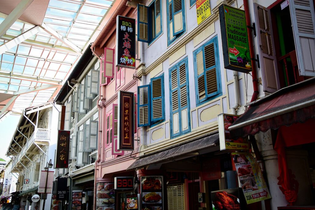 Vibrant outdoor view of traditional shop houses in Singapore's Chinatown, showcasing colorful architecture.