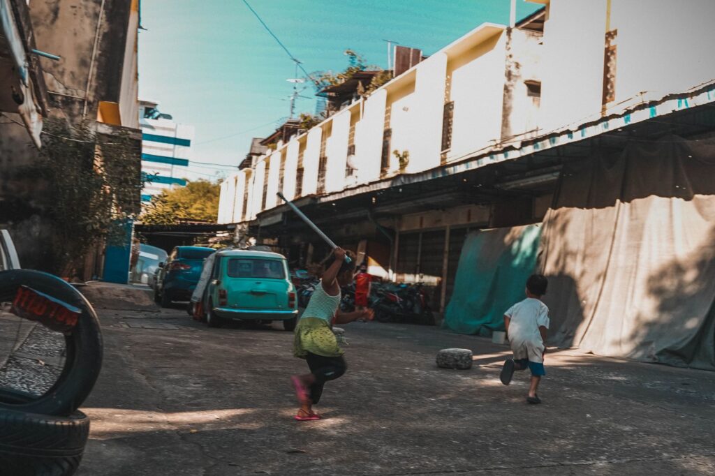 Kids running joyfully in a Bangkok suburb, capturing urban childhood adventures.