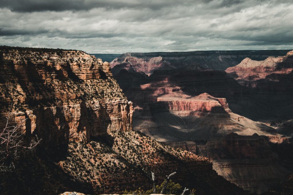 Capture of the Grand Canyon showcasing dramatic cliffs and cloudy skies.