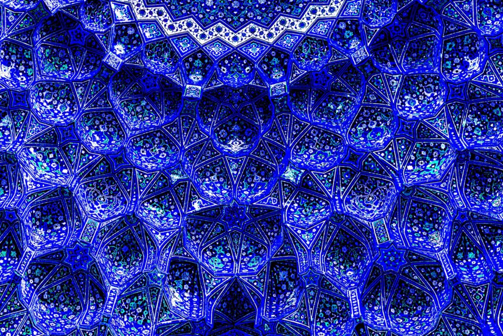 Stunning blue tile pattern from Isfahan's historical mosque, showcasing Persian architecture.