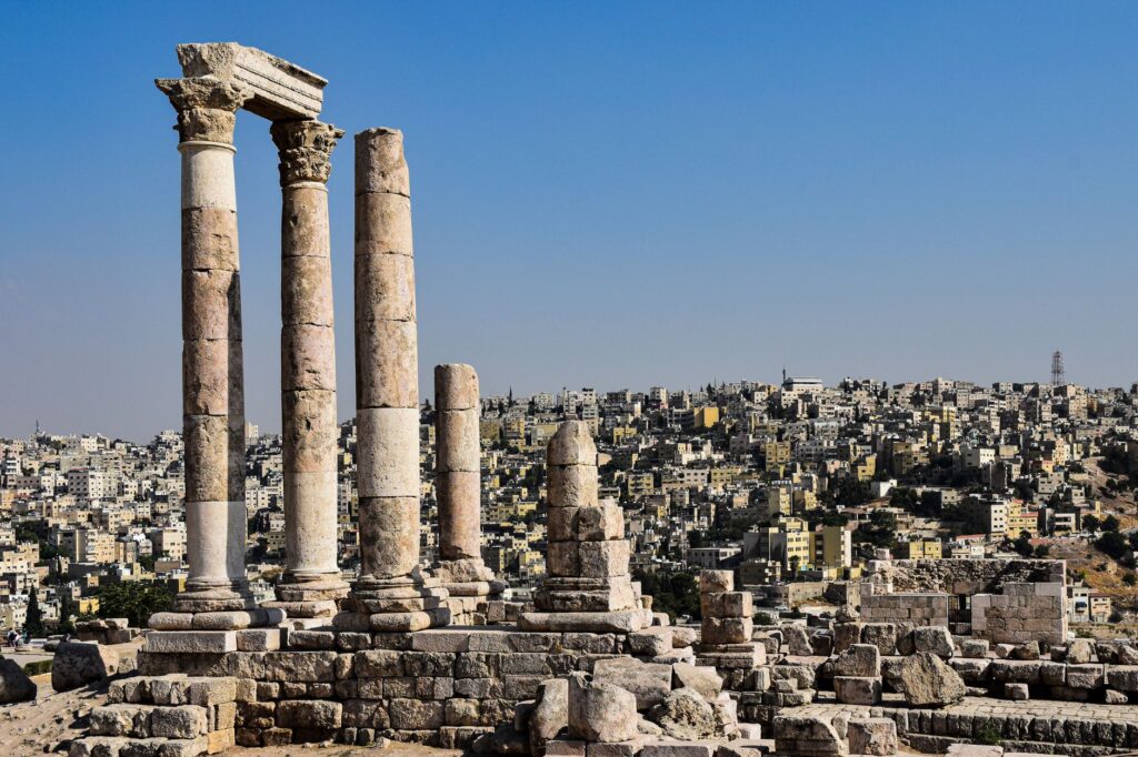 View of the ancient columns at Amman's Citadel with the cityscape in the background.