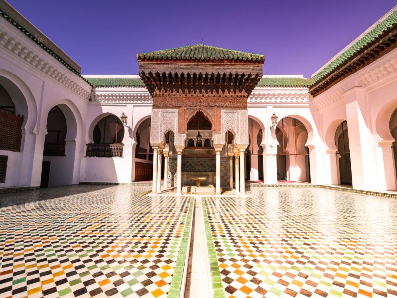 Stunning Moroccan courtyard showcasing traditional architecture and colorful tile patterns.