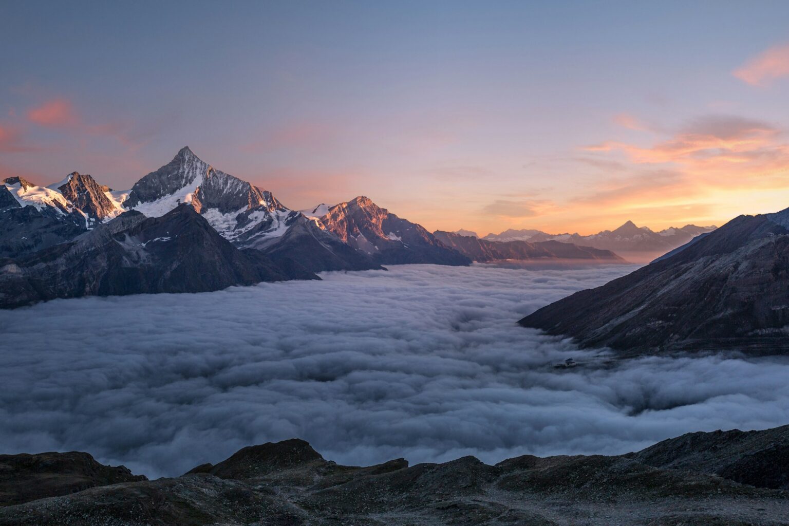 Alpine peaks above a sea of cloud at first light
