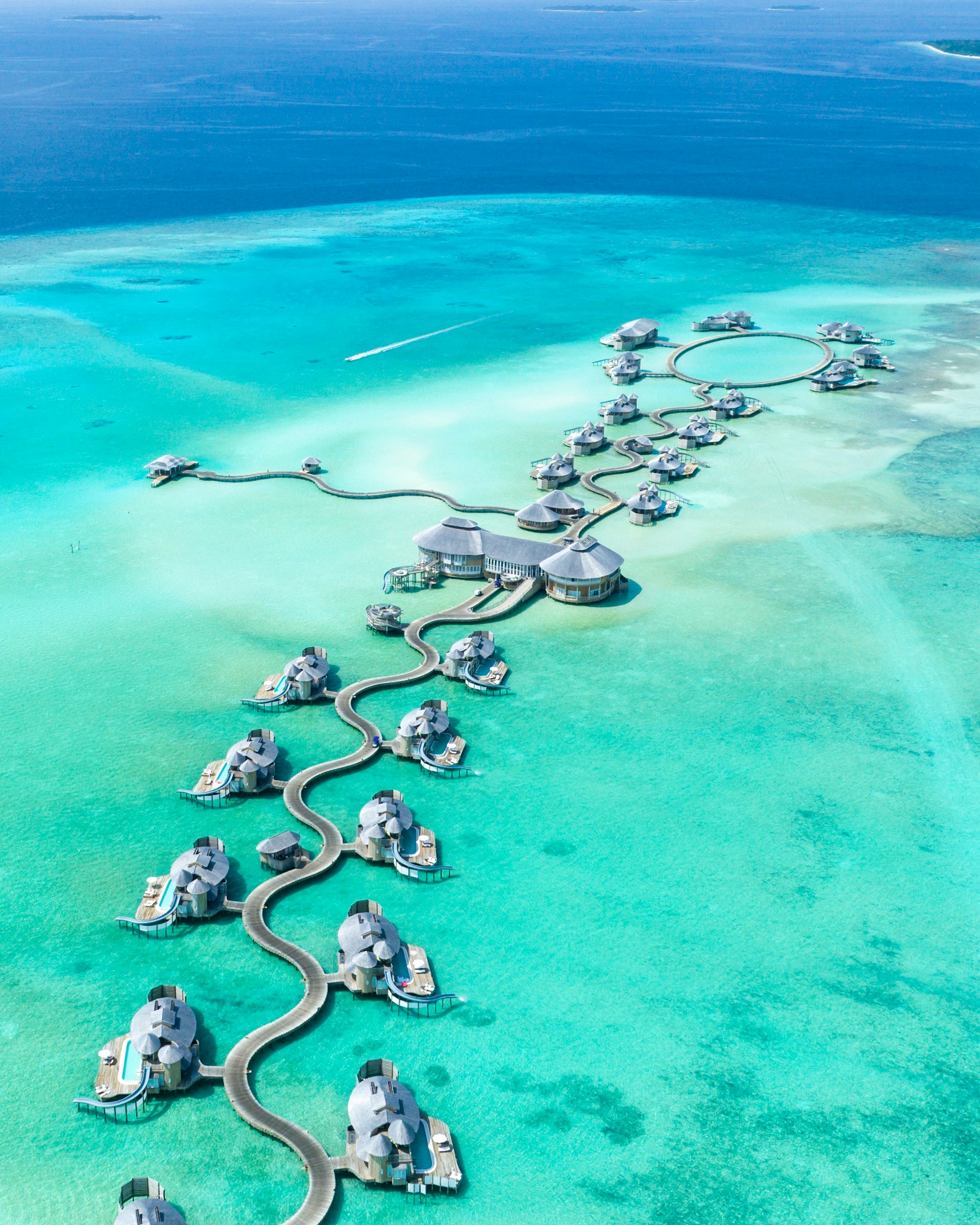 A jetty reaching into still turquoise water